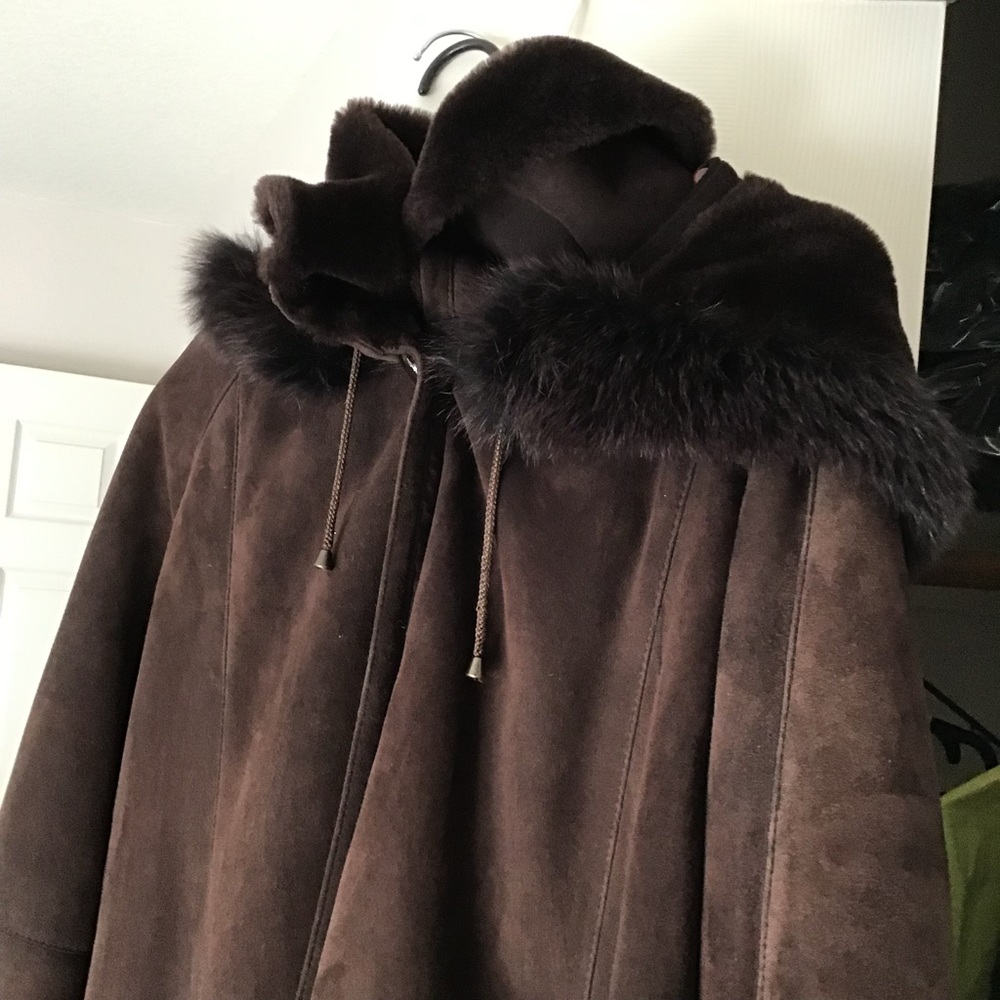 Like new, hooded sumptuous Shearling coat trimmed with dyed fox.